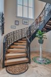 Up the beautiful custom wrought iron stairway to your suite